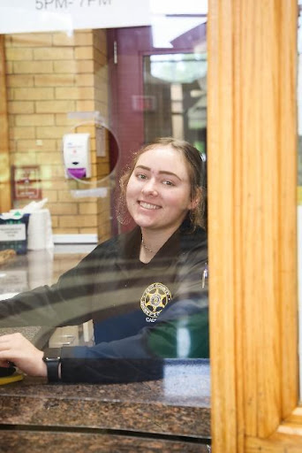 A cadet stands behind the Kent County Sheriff's front desk