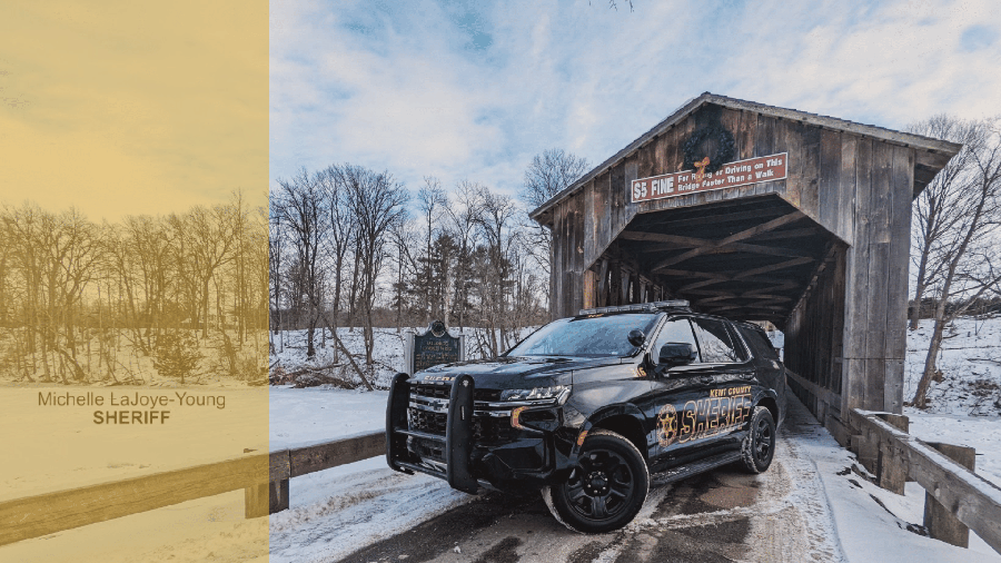 A Kent County Sheriff's Office cruiser parked on a covered bridge in the snow